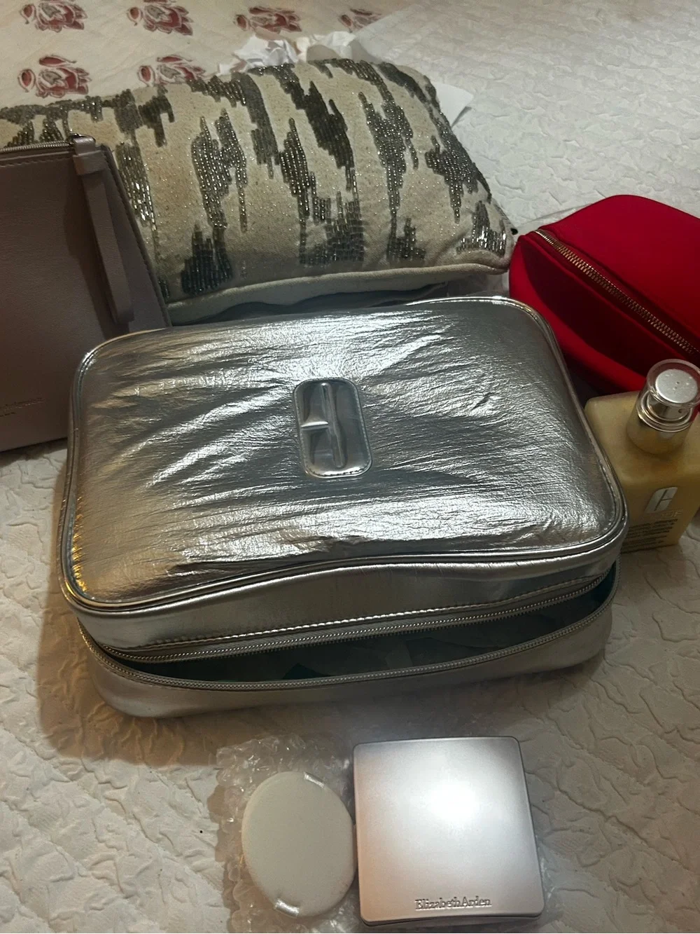 Clinique moisturizer & metallic travel bag plus Elizabeth Ard medium bronz.&bag